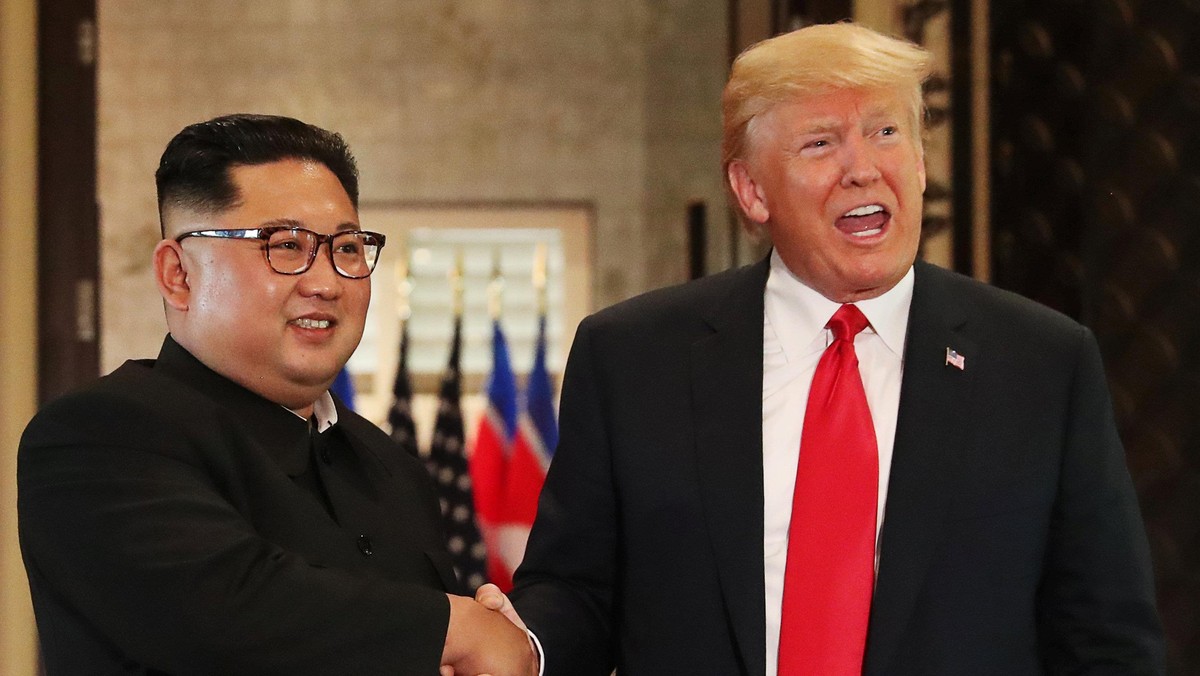 U.S. President Donald Trump and North Korea's leader Kim Jong Un shake hands after signing documents during a summit at the Capella Hotel on the resort island of Sentosa, Singapore