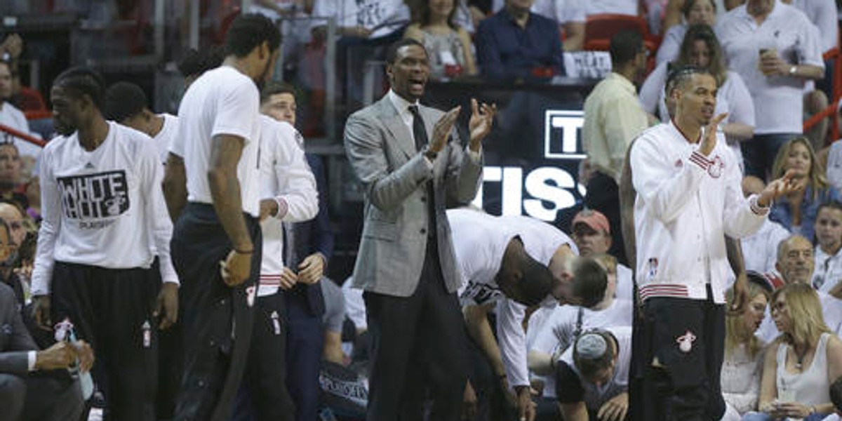 FILE - In this April 17, 2016 file photo, Miami Heat forward Chris Bosh, center, claps during the first half of Game 1 of a first-round NBA basketball playoff series against the Charlotte Hornets, in Miami. The Heat defeated the Hornets 123-91. Chris Bosh's season is now officially over, regardless of how far the Miami Heat advance in this postseason. The Heat and Bosh made the announcement Wednesday afternoon, May 4, 2016 after the team practiced in Toronto, ending rampant speculation in recent days that Bosh would try to return to the court during the playoffs. (AP Photo/Lynne Sladky, File)