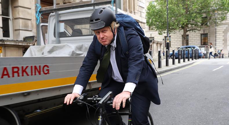 Boris Johnson riding a bicycle. Not the one Joe Biden gave him.
