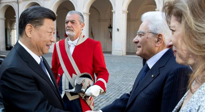 Chinese President Xi Jinping shakes hands with his Italian counterpart Sergio Mattarella in Rome