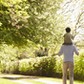 Rear View Of Family Going For Walk In Summer Countryside