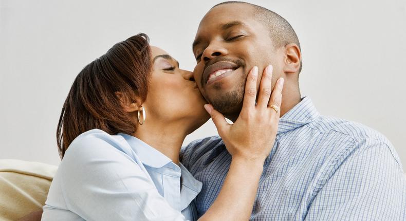 A happy wife lovingly kisses her husband on the cheek [Credit: Gloo]