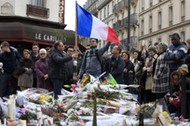 People pay tribute to victims outside Le Carillon restaurant, one of the attack sites in Paris