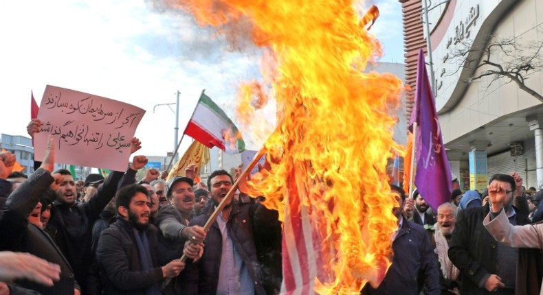 Iranian men burn a US flag during a protest in support of the Islamic republic's government and supreme leader Ayatollah Ali Khamenei