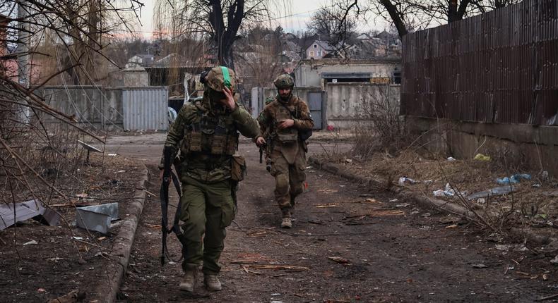 Ukrainian soldiers walk along a street in the area of the heaviest battles with the Russian invaders in Bakhmut, Donetsk region, Ukraine, on March 15, 2023.Roman Chop/AP