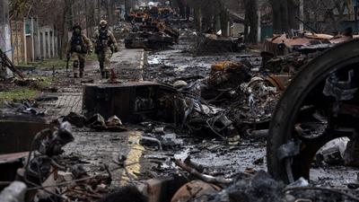 Soldiers walk amid destroyed Russian tanks in Bucha, in the outskirts of Kyiv, Ukraine, April 3, 2022.AP Photo/Rodrigo Abd, File