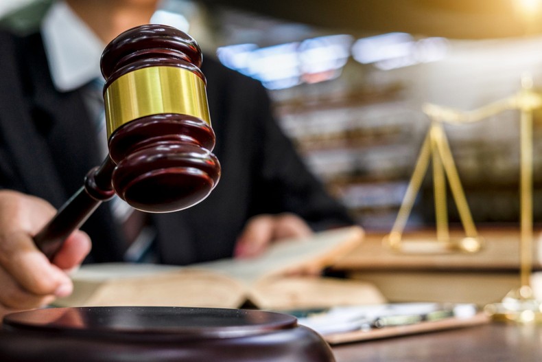 A judge uses a gavel in a courtroom.Naruecha Jenthaisong/Getty Images