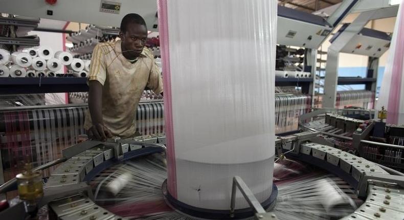 A worker fabricates a plastic bag designed to hold cotton at the Badenya Company factory in Koutiala August 31, 2012. 