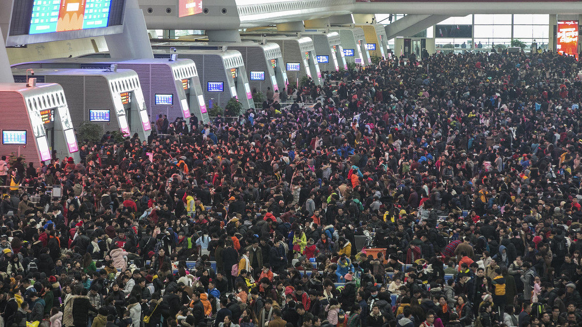 Passengers crowd at the waiting hall inside a railway station after trains were delayed due to heavy snow, during the travel rush ahead of the upcoming Spring Festival, in Hangzhou, Zhejiang province