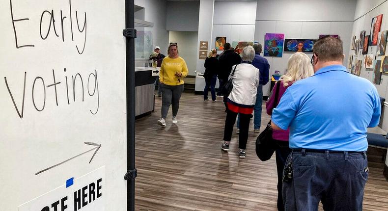 Early voters line up to cast ballots in the Senate runoff election between Democratic Sen. Raphael Warnock and Republican Herschel Walker in Kennesaw, Ga., on November 28, 2022.AP Photo/Mike Stewart