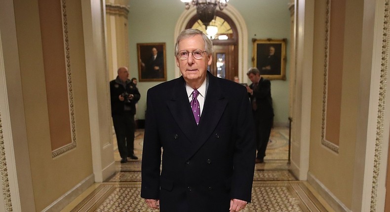 WASHINGTON, DC - FEBRUARY 08: Senate Majority Leader Mitch McConnell (L) (R-KY) returns to the U.S. Capitol just before midnight February 8, 2018 in Washington, DC. After a delay caused by Sen. Rand Paul (R-KY), both the Senate and the House of Representatives are expected to vote in the early morning on a long term funding bill following an agreement between Republican and Democratic leaders in the U.S. Senate. (Photo by Win McNamee/Getty Images)