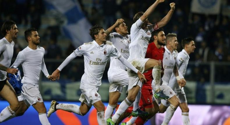 AC Milan's players celebrate at the end of the Italian Serie A football match between Empoli and AC Milan on November 26, 2016