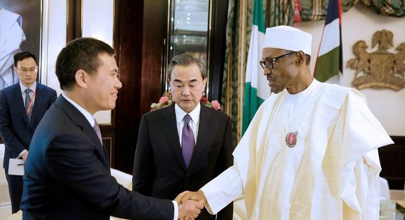 Nigeria’s President Muhammadu Buhari greets China’s Foreign Minister Wang Yi (C) and Chinese Ambassador to Nigeria Zhou Pingjian during their visit to the Presidential Villa in Abuja, Nigeria [REUTERS]