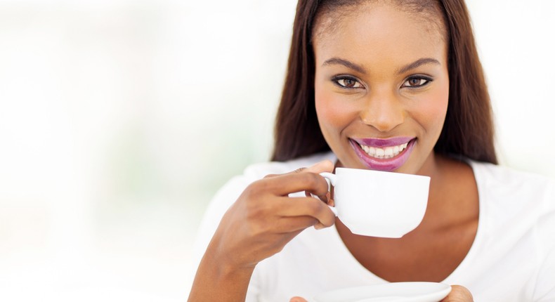 Beautiful woman drinking tea at home