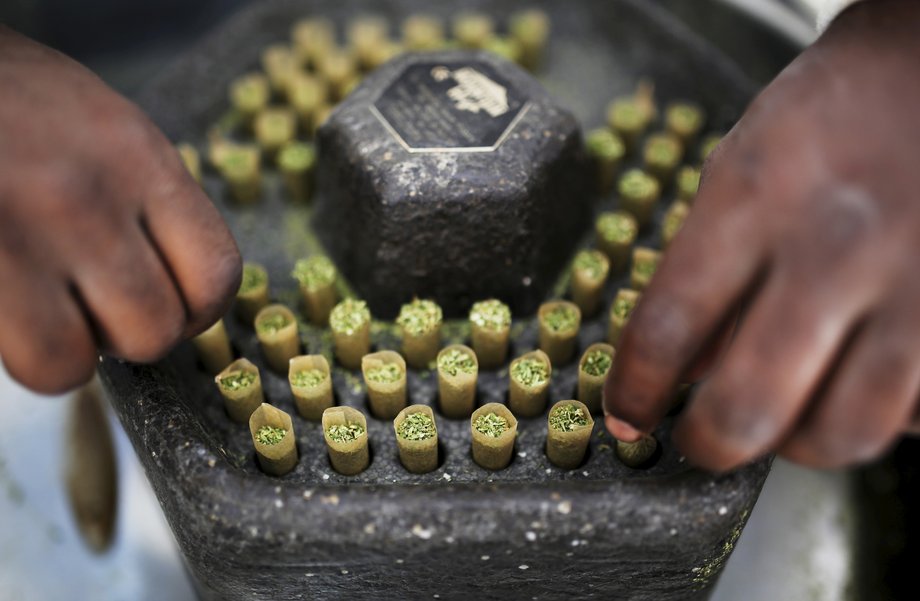 A worker places newly prepared cigarettes filled with medical marijuana at a plantation near Nazareth on May 28, 2013.