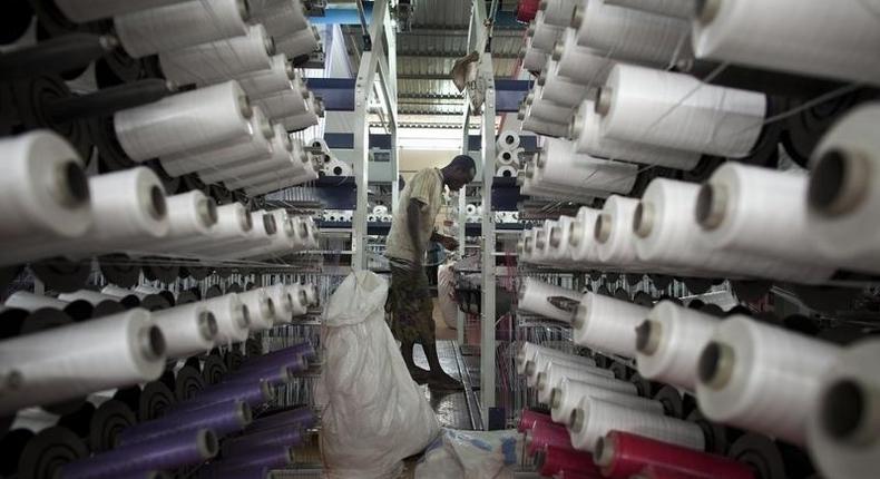 A worker fabricates a plastic bag designed to hold cotton at the Badenya Company in Koutiala, Mali August 31, 2012. REUTERS/Joe Penney