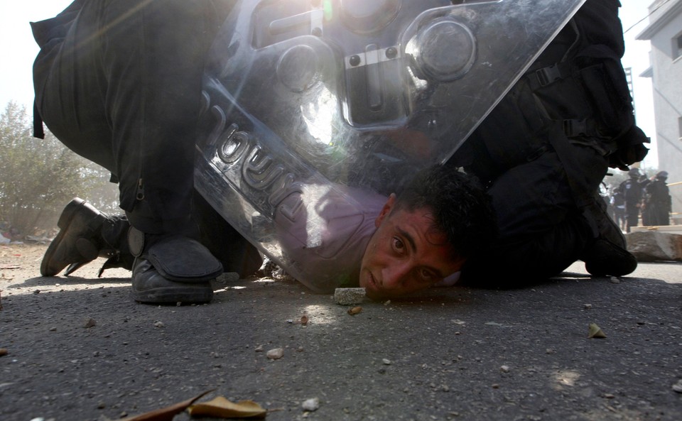 Israeli riot police restrain a protester during clashes in Umm el-Fahm