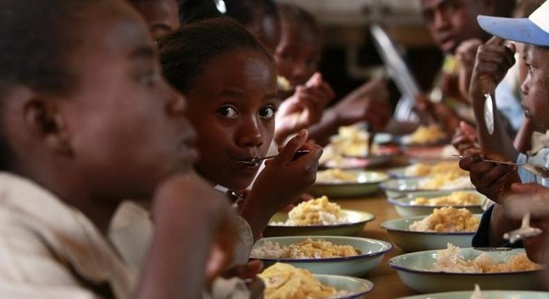 Malagasy children eat at the United Nations World Food Program (WFP) school feeding initiative at the Saint de Paul community centre in Tanjombato, a southern suburb of the capital Antananarivo, October 28, 2013. 