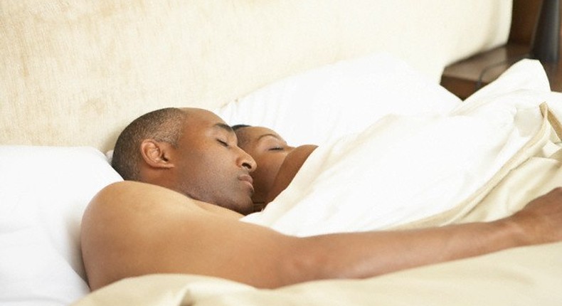 A black couple sleeping.