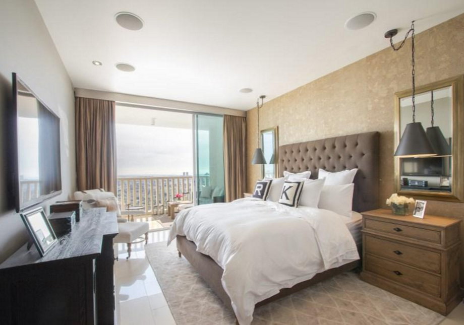 The bedrooms have large windows and boast neutral color palettes.