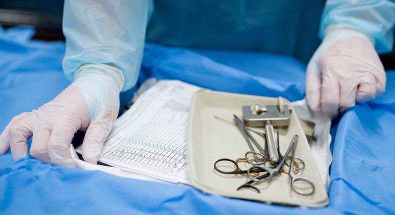 CARDIFF, UNITED KINGDOM - MAY 25: A surgeon with surgical tools in an operating theatre on May 25, 2017 in Cardiff, United Kingdom.