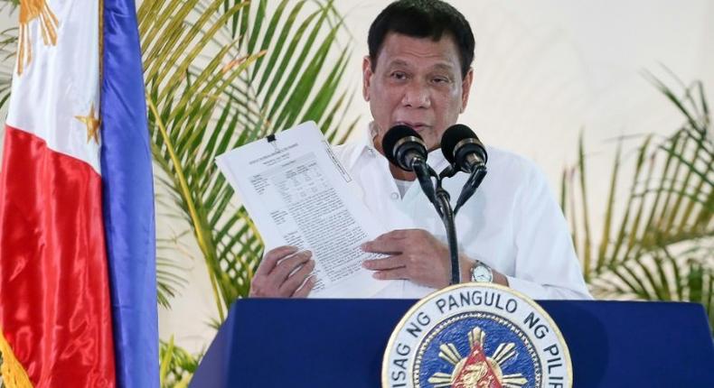 Philippine President Rodrigo Duterte delivers a speech at Davao airport on the southern island of Mindanao on November 17, 2016