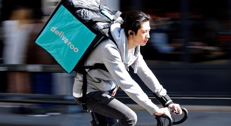 A cyclist rides a bicycle as he delivers food for Deliveroo.