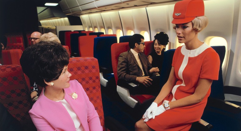 A United flight attendant wears the airline's coral-red uniform in May 1968.Dean Conger/Corbis via Getty Images