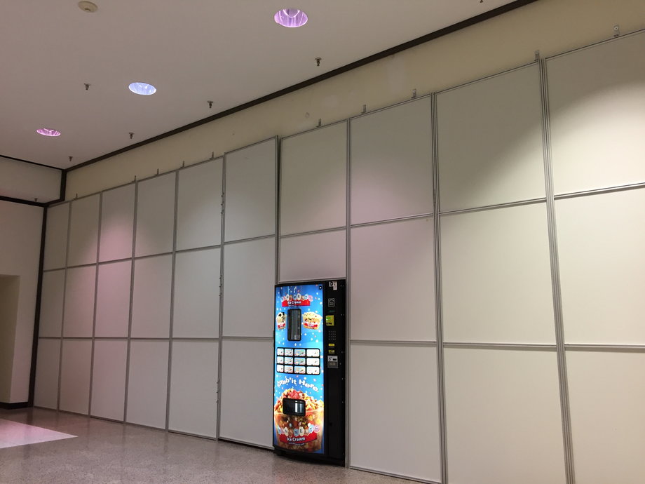 A former Macy's entrance at Regency Square Mall in Richmond, Virginia, now features a boarded-up wall and vending machine.