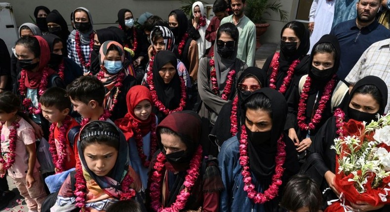 The team wore garlands and dressed in burqas as they arrived at the Pakistan Football Federation in Lahore Creator: Arif ALI