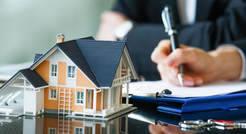 Homebuyers signing a mortgage.Getty Images