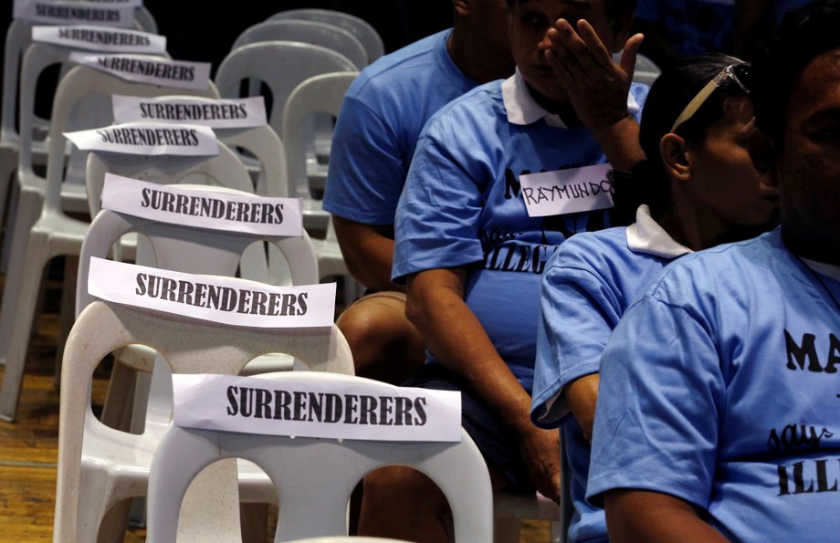 Residents involved with illegal drugs wait for fellow surrenderees before taking a pledge that they will not use or sell "Shabu" (meth) again after surrendering to police and government officials in Makati, metro Manila, Philippines, August 18, 2016