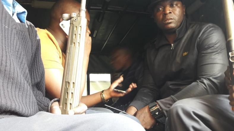 MP Benjamin Gathiru (in yellow shirt) at the back of a police Land Rover (twitter) 