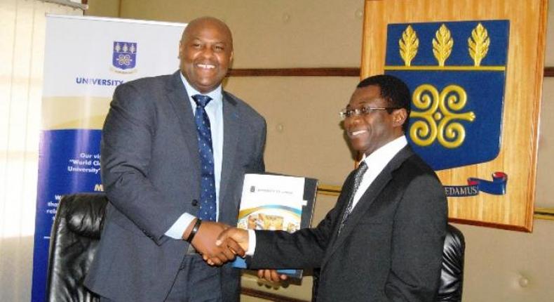 Prof. Kwame Offei,  Pro-Vice Chancellor in charge of Academic and Student Affairs, and Mr. Leslie Nelson, Chief Executive Officer, GE, Ghana in a handshake after signing the MOU