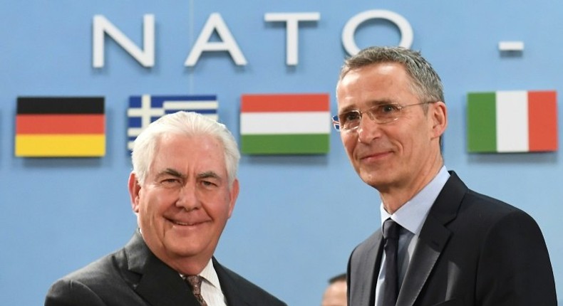 NATO Secretary General Jens Stoltenberg (R) greets US Secretary of State Rex Tillerson who called on alliance allies to meet their funding pledge