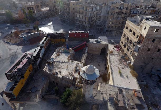 A view taken with a drone shows damaged buses positioned as barricades in the rebel-held Bab al-Hadi