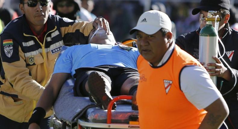 Bolivian referee Victor Hugo Hurtado is taken away on a stretcher during Bolivia's first division football match between Always Ready and Oriente Petrolero at the Municipal Stadium in El Alto, Bolivia on May 19, 2019
