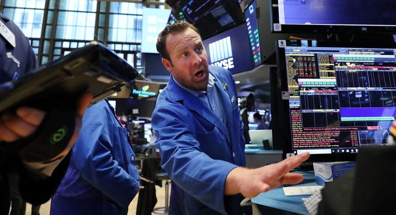 Traders work on the floor of the New York Stock Exchange (NYSE)