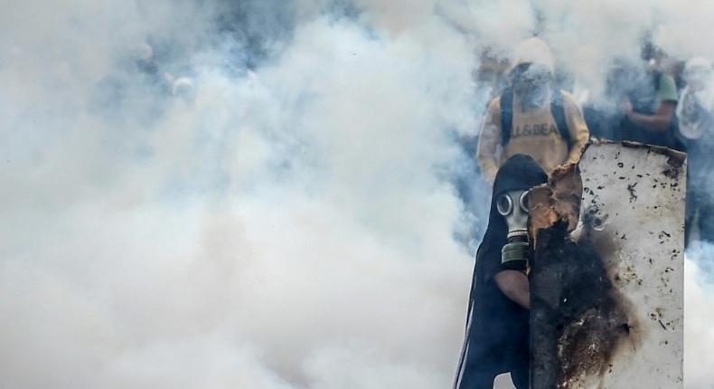 Demonstrators clash with riot police in the latest of a series of violent protests over the economic crisis gripping Venezuela