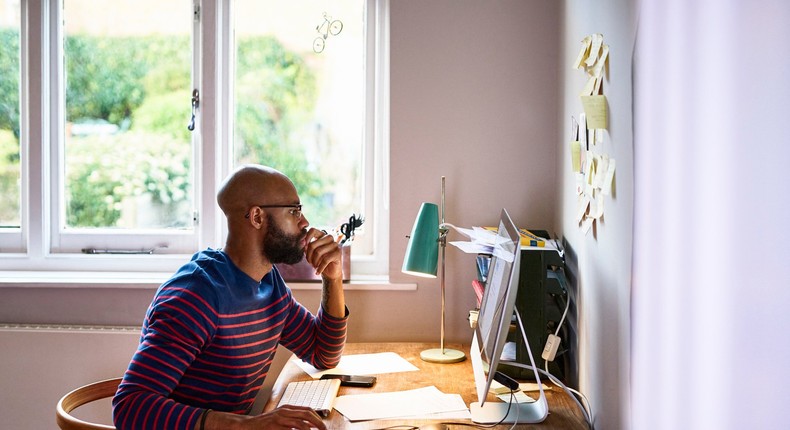 man using computer in home office