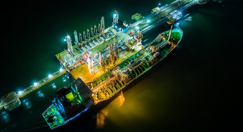 Aerial top view tanker ship loading Liquefied Petroleum from refinery bridge on the night.