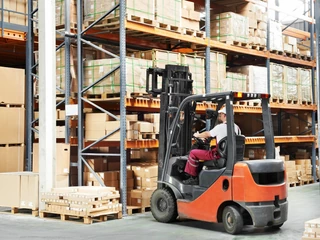 worker driver at warehouse forklift loader works