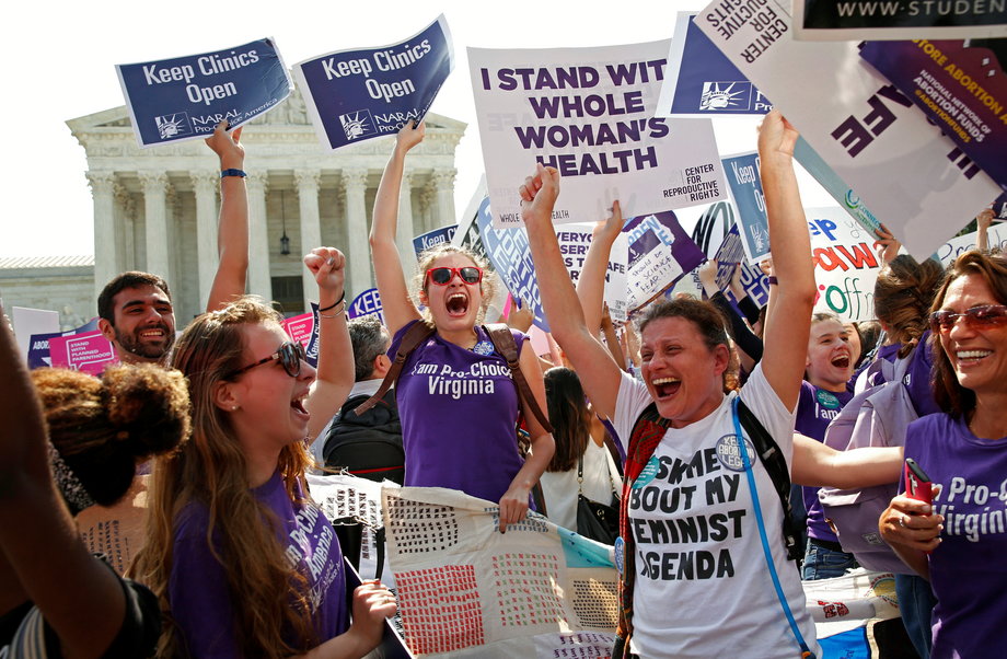 Demonstrators celebrate at the US Supreme Court after the court struck down a Texas law imposing strict regulations on abortion doctors and facilities that its critics contended were specifically designed to shut down clinics in Washington, June 27, 2016.
