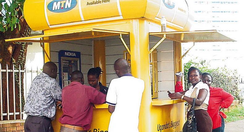 A mobile money vendor attending to customers in Ghana