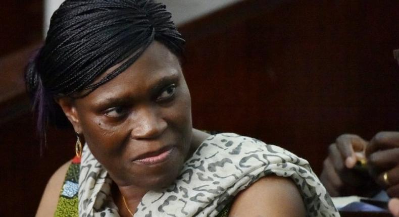 Former Ivorian first lady Simone Gbagbo looks on at Abidjan's courthouse on October 10, 2016 before the re-opening of her trial
