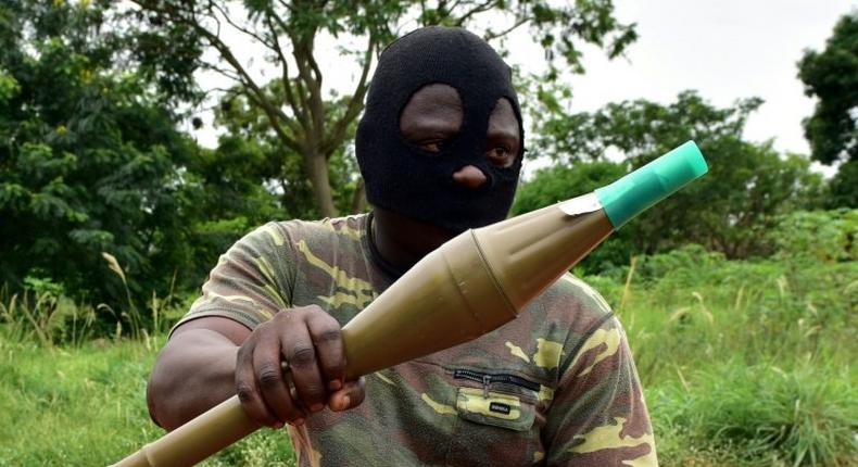 A mutinous soldier holds an RPG rocket launcher inside a military camp in Ivory Coast's second city Bouake, where the rebellion first erupted in January