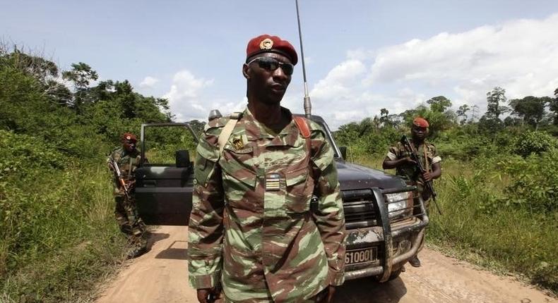 Losseni Fofana of the Ivory Coast Republican forces (FRCI) and commander of the military operation in the Tai area, stands with his men during a patrol on the road to Para village, in the western Tai area near Ivory Coast's border with Liberia, June 17, 2012. REUTERS/Luc Gnago