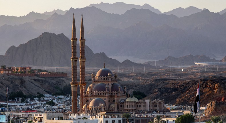 This picture taken on November 19, 2022 shows a view of the old market area of Egypt's Red Sea resort city of Sharm el-Sheikh and the Grand Mosque of al-Sahaba (Companions of the Prophet) at sunset during the COP 27 climate conference.AHMAD GHARABLI/AFP via Getty Images