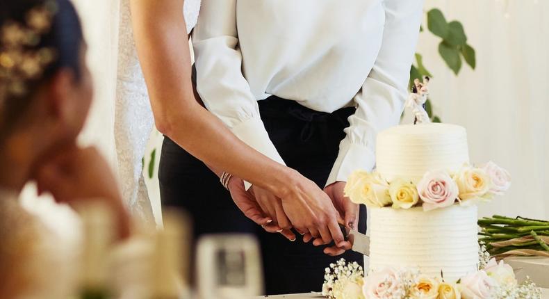 A couple cuts a wedding cake. Yawn.LumiNola/Getty Images