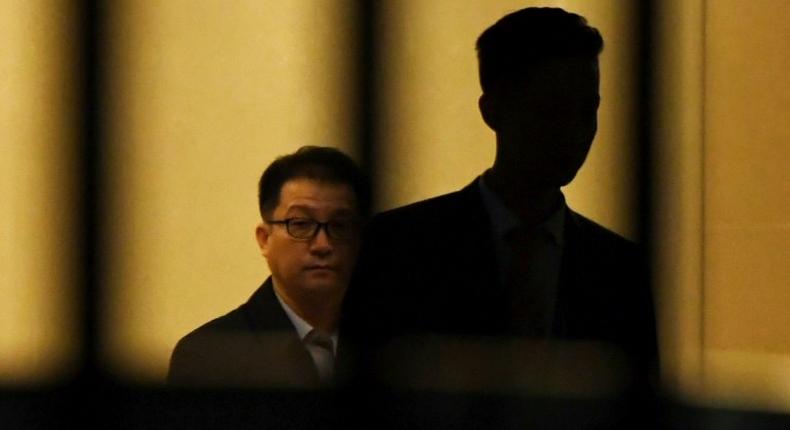 A North Korean official pushes a cart through the VIP entrance at Beijing airport after a flight from Malaysia believed to be carrying the body of Kim Jong-Nam arrived in the Chinese capital